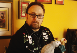 Chris Bennett (with parrot Popeye) has spent $15,000 in legal fees, money he's recouping through an online retail store
